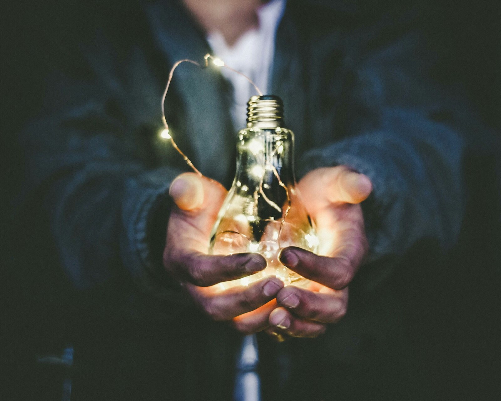Hand holding an incandescent bulb